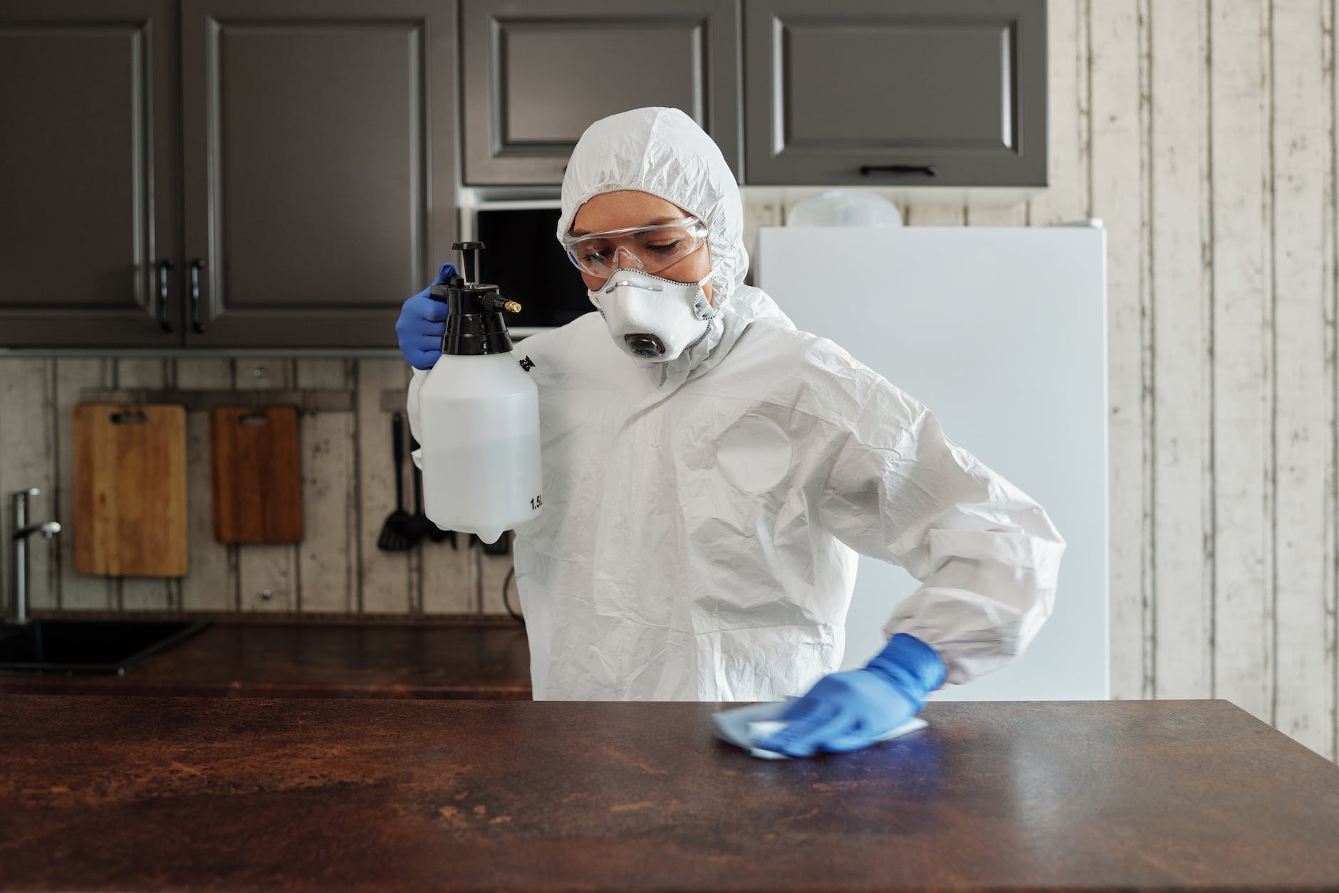photo of person disinfecting the table